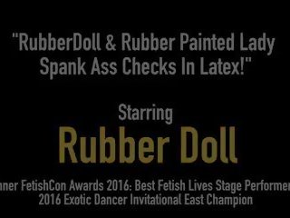 Rubberdoll & Rubber Painted babe Spank Ass Checks in.