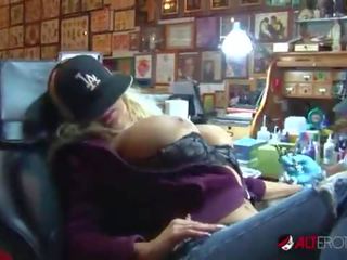 Shyla Stylez gets tattooed while playing with her tits